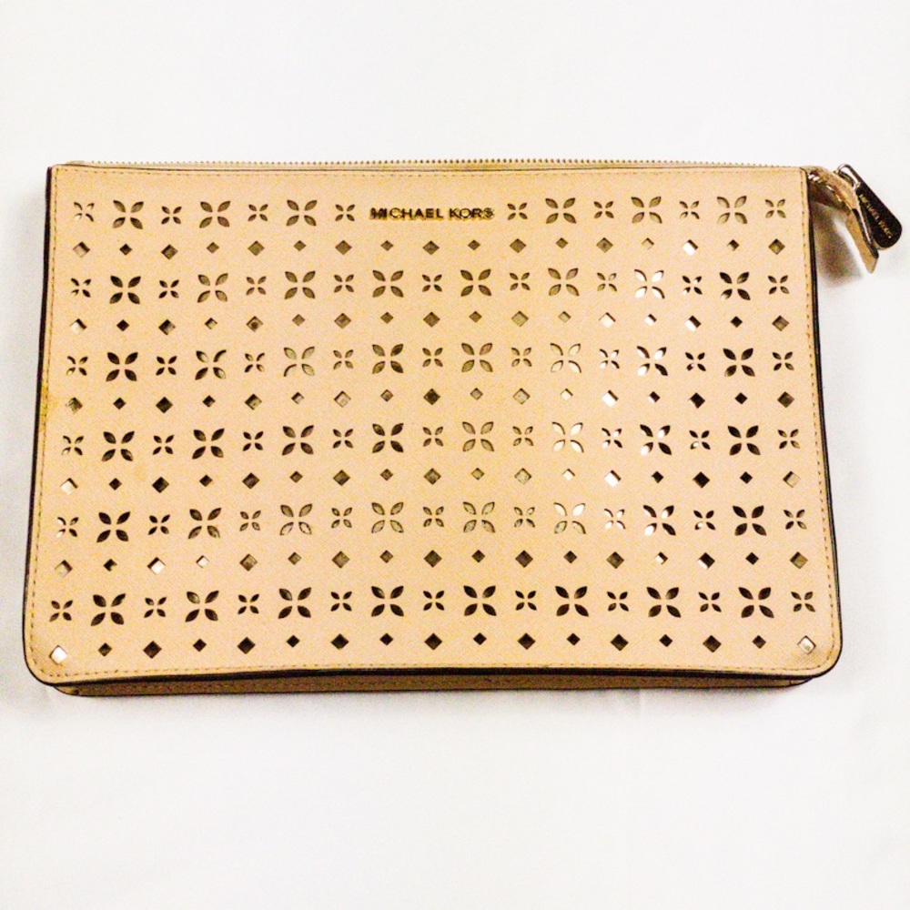 Small, pink Michael Kors clutch purse.